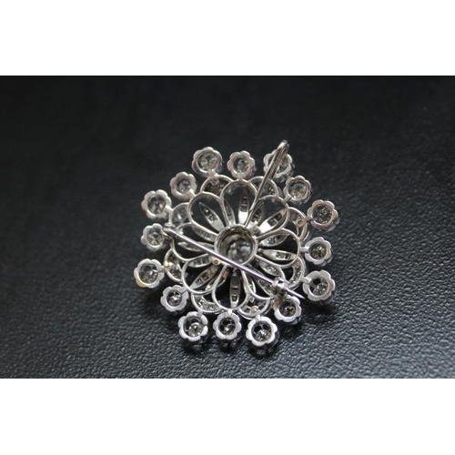 641 - A DIAMOND ENCRUSTED PENDANT BROOCH, set with a central diamond of an estimated 1.07 carats, which is... 