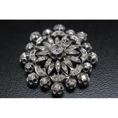 641 - A DIAMOND ENCRUSTED PENDANT BROOCH, set with a central diamond of an estimated 1.07 carats, which is... 