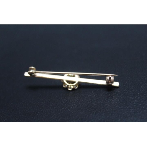 671 - A DIAMOND 'FLOWER' BAR BROOCH, the diamonds on a rub over setting on unmarked yellow metal brooch, a... 