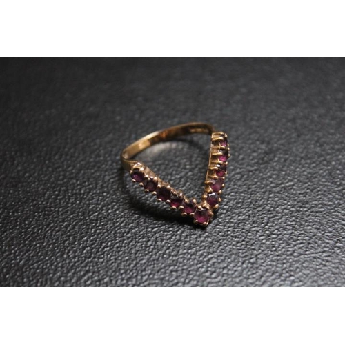 682 - A HALLMARKED 9 CARAT GOLD V SHAPED RING, set with ruby type stones, approx weight 2.3g