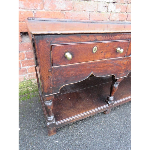 1170 - A 19TH CENTURY OAK DRESSER - POSSIBLY SHROPSHIRE, having three frieze drawers above a shaped apron, ... 