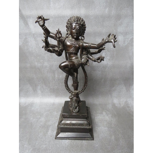 1041 - AN EASTERN BRONZE FIGURE OF DANCING EIGHT ARMED SHIVA, standing one legged atop an elephant head on ... 