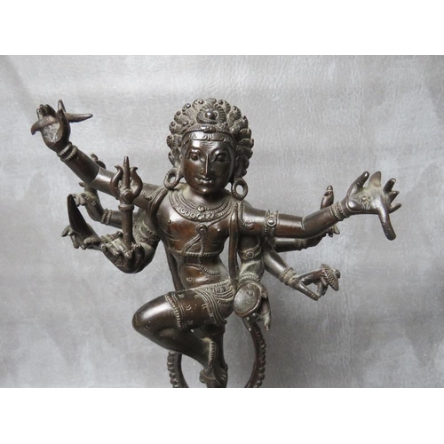 1041 - AN EASTERN BRONZE FIGURE OF DANCING EIGHT ARMED SHIVA, standing one legged atop an elephant head on ... 