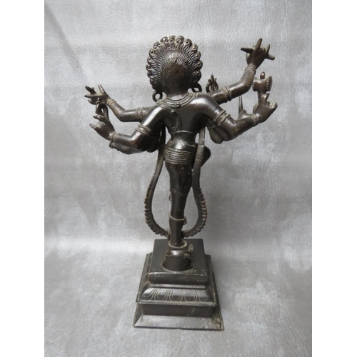 1041 - AN EASTERN BRONZE FIGURE OF DANCING EIGHT ARMED SHIVA, standing one legged atop an elephant head on ... 