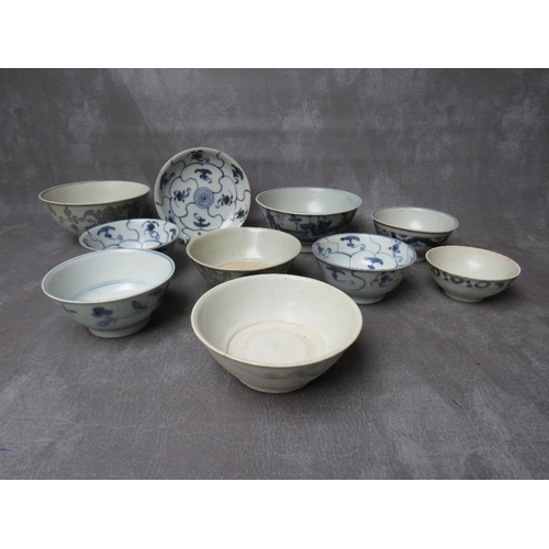 1028 - A COLLECTION OF NINE TEK SING CARGO BLUE AND WHITE BOWLS, together with a shallow saucer, all with N... 