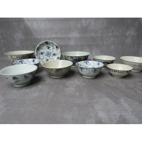 1028 - A COLLECTION OF NINE TEK SING CARGO BLUE AND WHITE BOWLS, together with a shallow saucer, all with N... 