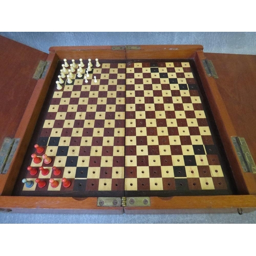 1075 - AN EDWARDIAN MAHOGANY TRAVELLING CHESS BOX, with some pieces included, L 30 cm, W 15 cm, D 7 cm