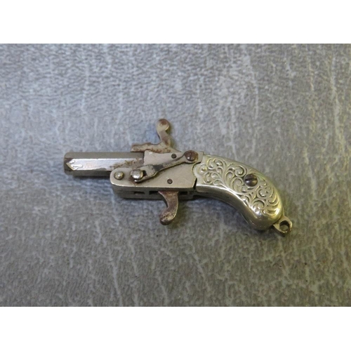 604 - A VINTAGE AUSTRIAN WHITE METAL PERCUSSION PISTOL FOB, L 3.5 cm