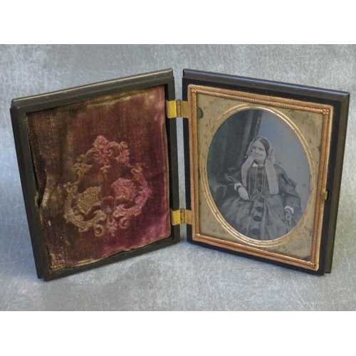 1112 - A 19TH CENTURY AMERICAN AMBROTYPE OF A SEATED LADY, in decorative case, portrait size 9 x 6.5 cm, ca... 