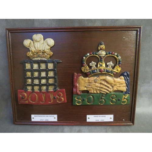 1105 - TWO PAINTED LEAD FIREMARKS SET ON A WOODEN PLAQUE, 'Westminster Fire Office 1717-1906' and 'Hand in ... 