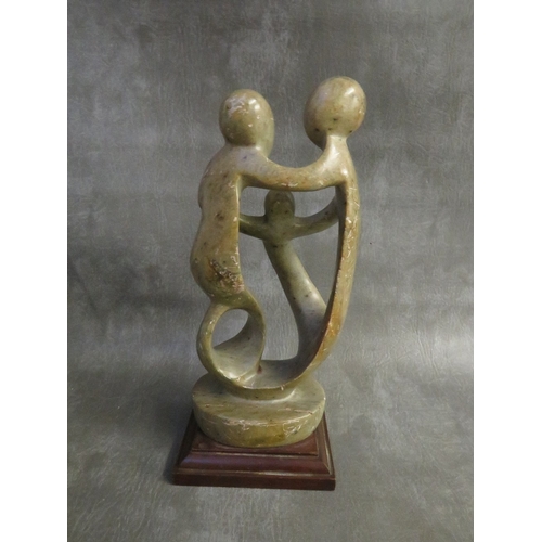 1104 - A MODERN BRITISH SCHOOL ABSTRACT SCULPTURE, depicting three figures on a wooden base, H 30 cm