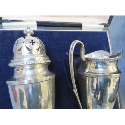 799 - A CASED HALLMARKED SILVER STRAWBERRY SET, comprising a tall cream jug and sugar sifter, Birmingham 1... 