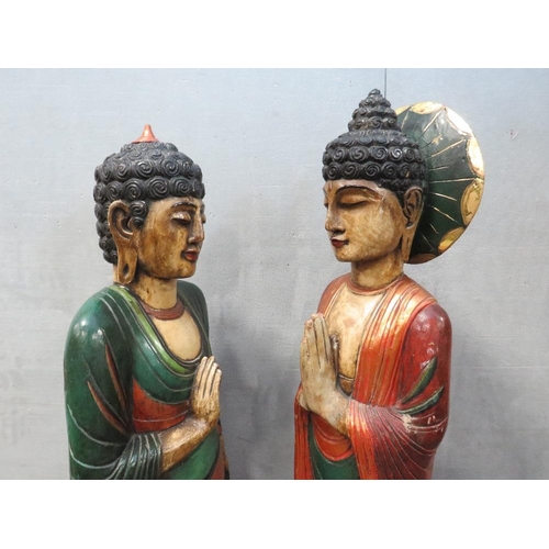 1072 - TWO LARGE CARVED WOOD POLYCHROME ORIENTAL DEITY FIGURINES, circa 1960s, in majestic standing pose, t... 