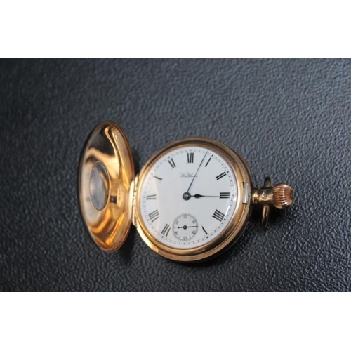 714 - A HALLMARKED 9 CARAT GOLD HALF HUNTER FOB WATCH, on a long muff style gold plated chain with floatin... 