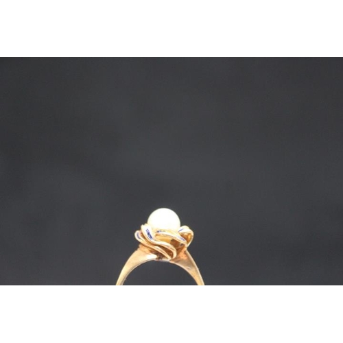 697 - A PEARL RING, set in yellow metal stamped k15 on a 'swirl' bed with blue enamelling, A/F approx weig... 