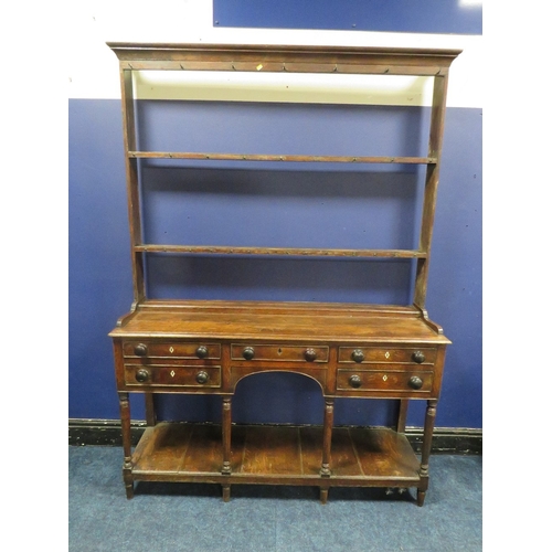 1154 - A 19TH CENTURY OAK DRESSER, with an arrangement of five drawers over an arched apron, raised on turn... 