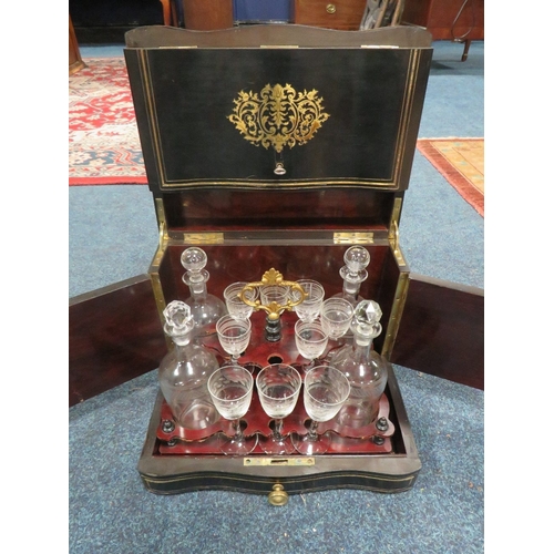 1160 - A 19TH CENTURY EBONISED AND BRASS INLAID DOMED DRINKS CABINET, the hinged lid opening to reveal and ... 