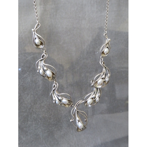 602 - MEREDITH, SCOTLAND - A SILVER AND FRESHWATER PEARL NECKLACE, the pearls in a freeform Art Nouveau st... 