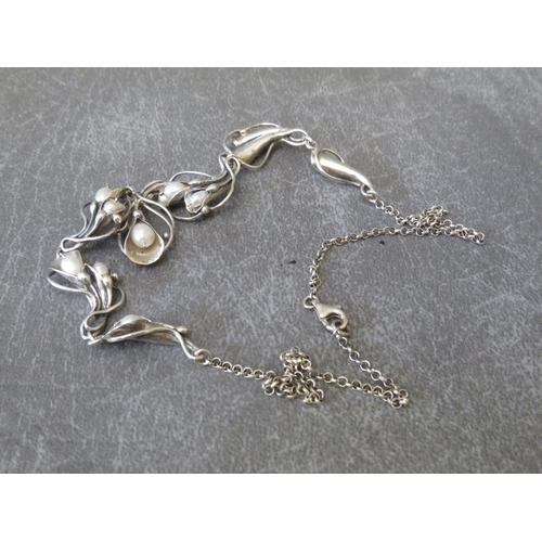 602 - MEREDITH, SCOTLAND - A SILVER AND FRESHWATER PEARL NECKLACE, the pearls in a freeform Art Nouveau st... 