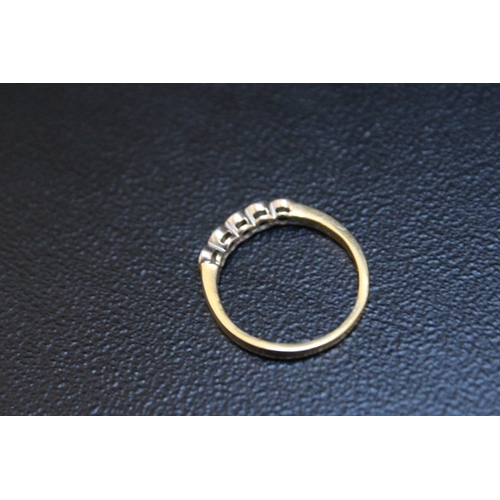 702 - AN 18 CARAT GOLD FIVE STONE DIAMOND RING, in a rub over setting, approx weight 3.1g, ring size O