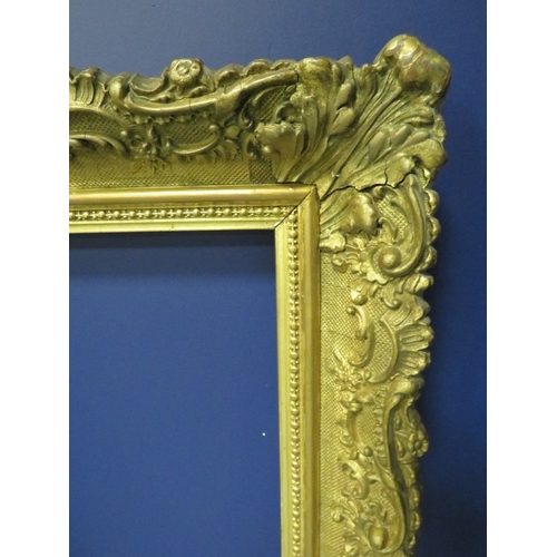 433 - A 19TH CENTURY DECORATIVE GOLD FRAME, frame W 7 cm, rebate 54 x 30 cm