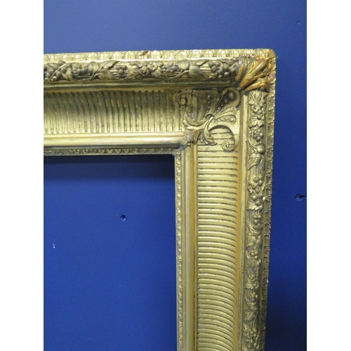 434 - A 19TH CENTURY GOLD FRAME, with fruit and leaf design to outer edge, frame W 11 cm, rebate 101 x 80 ... 