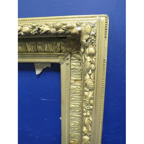 435 - A 19TH CENTURY GOLD FRAME, with fruit and leaf design to outer edge and leaf design to inner, frame ... 