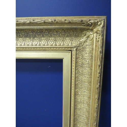 436 - A 19TH CENTURY DECORATIVE GOLD FRAME, frame W 11.5 cm, rebate 69 x 54 cm