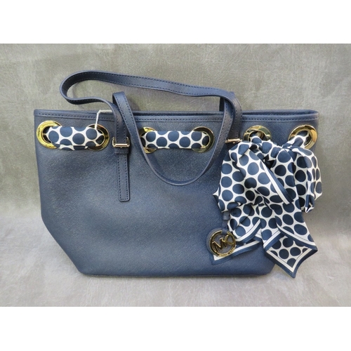 561 - A MICHAEL KORS NAVY BLUE LEATHER TOTE BAG WITH POLKA DOT SCARF EMBELLISHMENT, with twin carry handle... 