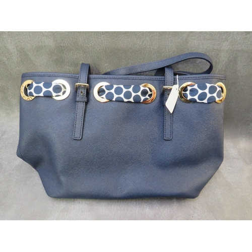 561 - A MICHAEL KORS NAVY BLUE LEATHER TOTE BAG WITH POLKA DOT SCARF EMBELLISHMENT, with twin carry handle... 