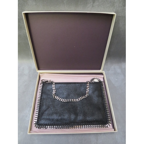 562 - A BOXED STELLA McCARTNEY BLACK LEATHER POUCH TYPE EVENING BAG, gunmetal colour hardware, H 16 cm, W ... 