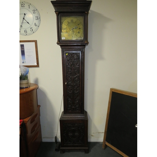 1147 - THOMAS WOODRUFF OF SALOP - A BRASS FACED CARVED OAK LONGCASE CLOCK, the face with date aperture and ... 