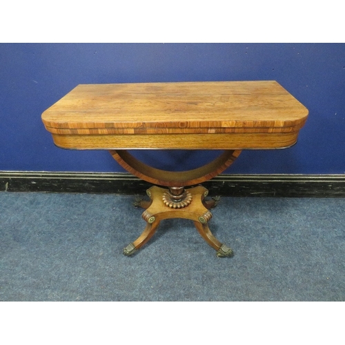 1178 - A REGENCY ROSEWOOD FOLD-OVER CARD TABLE, opening to a green baize surface, raised on a demi-lune sup... 