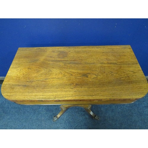 1178 - A REGENCY ROSEWOOD FOLD-OVER CARD TABLE, opening to a green baize surface, raised on a demi-lune sup... 