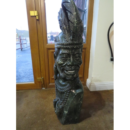 1186 - AN AFRICAN CARVED STONE SCULPTURE DEPICTING A TRIBAL MAN IN TRADITIONAL ATTIRE, 'Zulu King'  includi... 