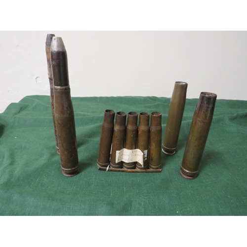 114 - A COLLECTION OF WW2 SHELL CASES, of German 2cm anti-aircraft rounds dated 1944 and a clip of K39 ant... 