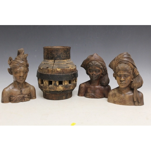 1049 - THREE INDONESIAN TRIBAL ART CARVED TEAL WOOD BUSTS, and a large heavy Indian cartwheel hub