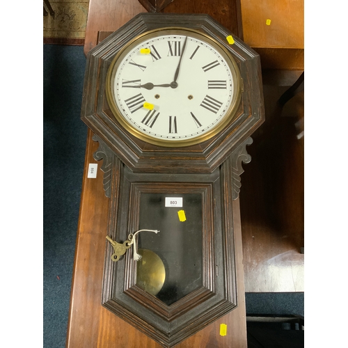 803 - An antique oak cased wallclock with key and pendulum