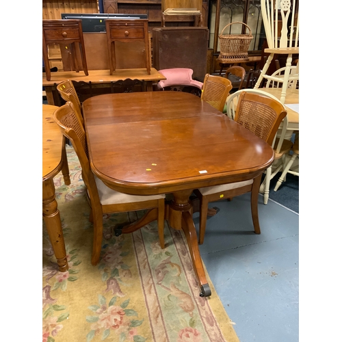 815 - A ‘Willis & Gambier’ extending twin pedestal dining table and four bergere chairs