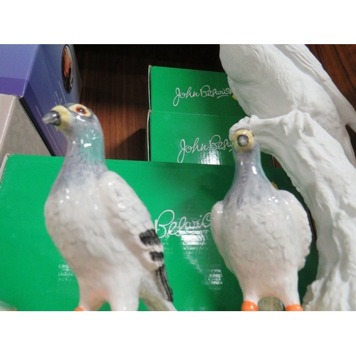 310 - Two modern John Beswick pigeons together with a John Beswick parrot