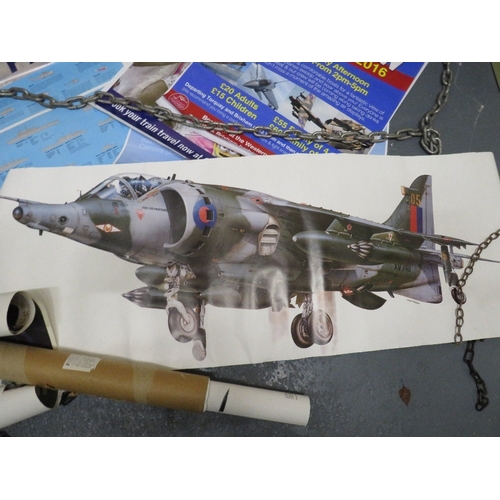 30 - A selection of military posters to include a helicopter cockpit training board, various aircraft pos... 