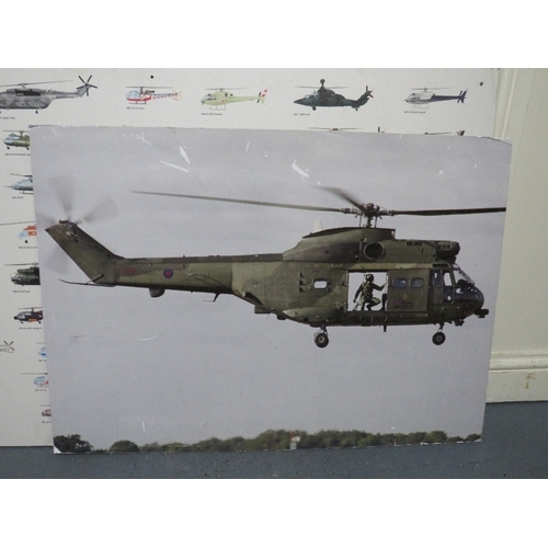 30 - A selection of military posters to include a helicopter cockpit training board, various aircraft pos... 