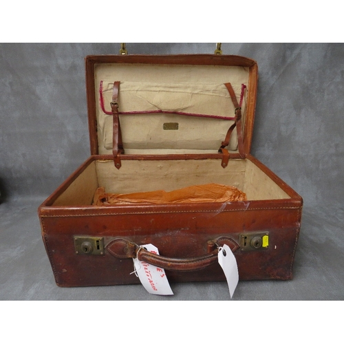 25 - AN EARLY 20TH CENTURY POLISHED LEATHER SUITCASE, with brass furniture, with presentation plaque read... 