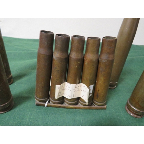 114 - A COLLECTION OF WW2 SHELL CASES, of German 2cm anti-aircraft rounds dated 1944 and a clip of K39 ant... 