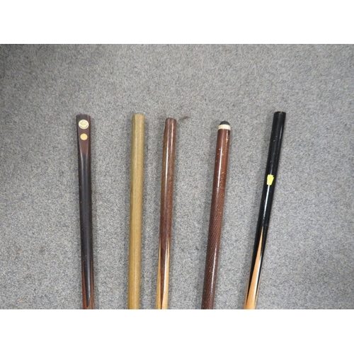 313 - A selection of vintage snooker cues together with two walking sticks