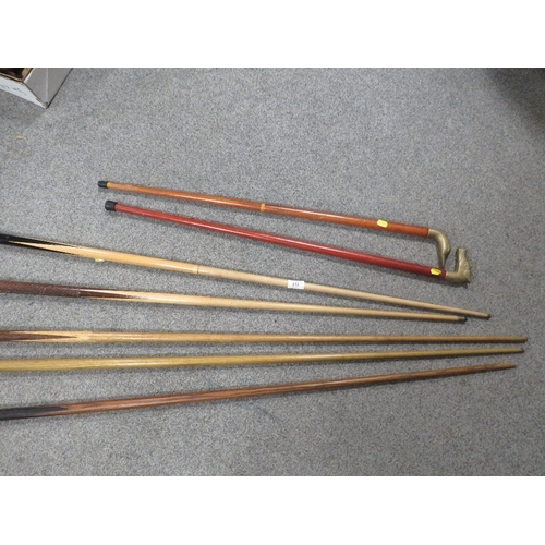 313 - A selection of vintage snooker cues together with two walking sticks