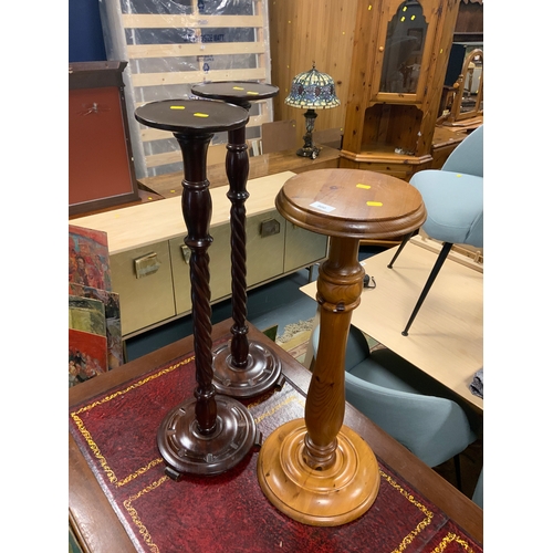 800 - A pair of turned torchieres and a pine stand. (3)