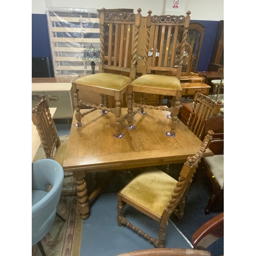 803 - An oak barleytwist drawleaf table with six chairs