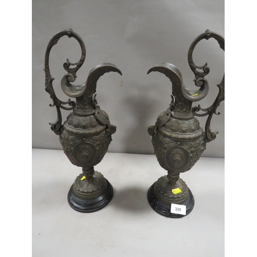 329 - A pair of ornate cast metal ewers