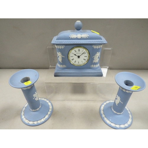 395 - A Wedgwood blue jasperware dancing hours clock and matching candlesticks